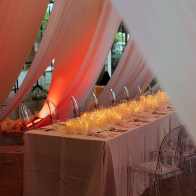 Candlelit dinner table with white drapes at The Lobby at EX8
