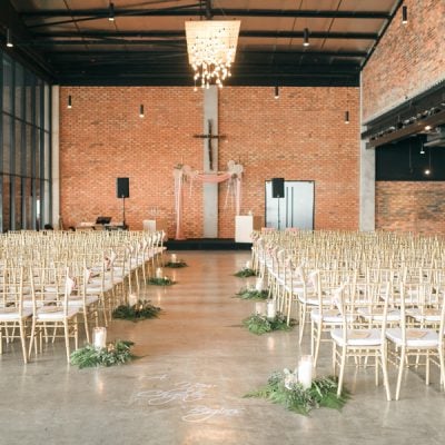 Wedding ceremony hall with glass walls and exposed brick at The Lobby at EX8, Subang Jaya